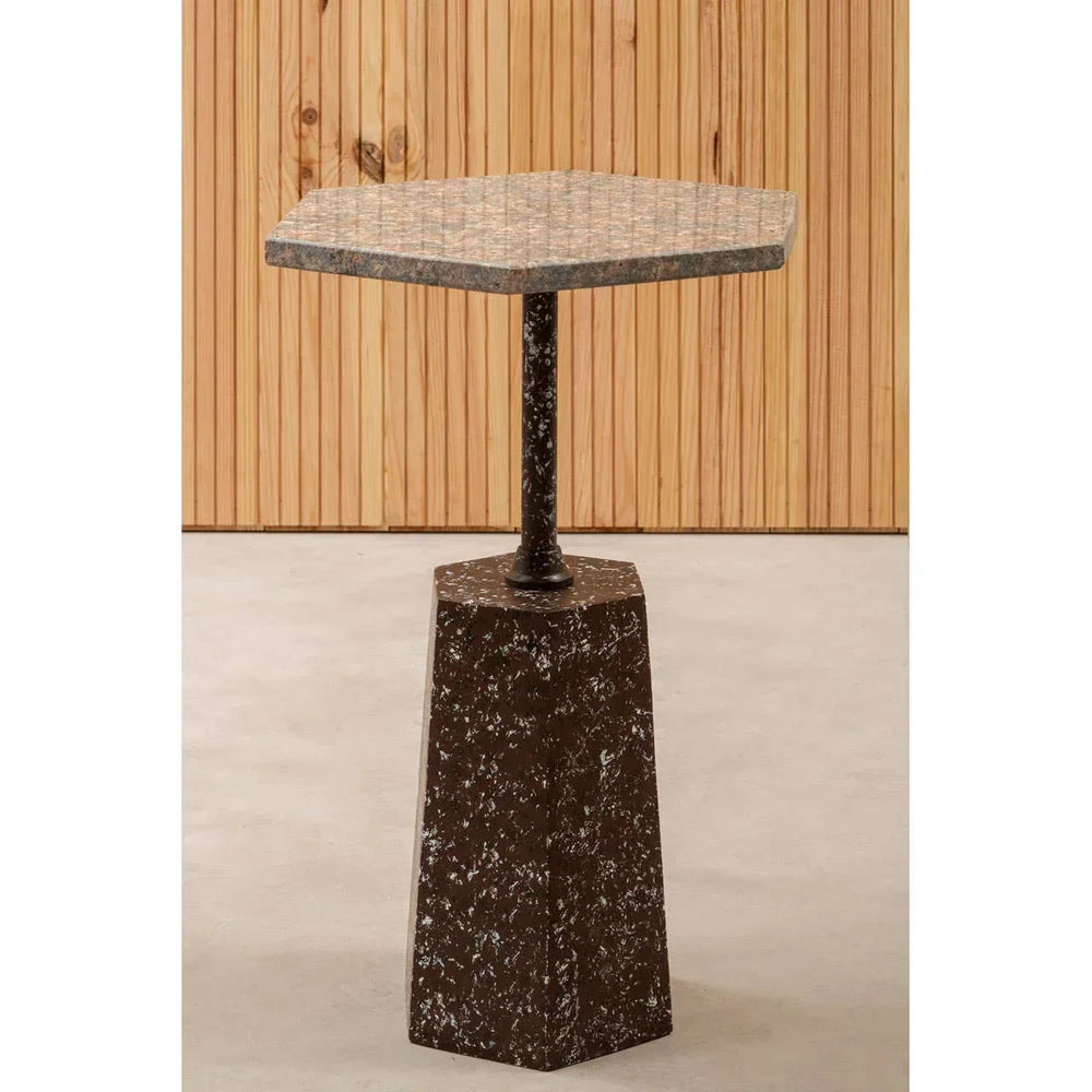 Hexagonal marble side table with brown speckled base and metal support, indoor setting