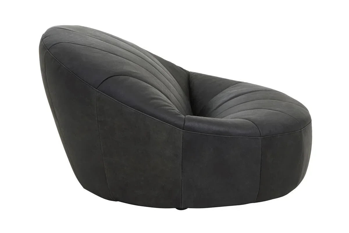Curved black accent chair with channel tufted upholstery, side angle view