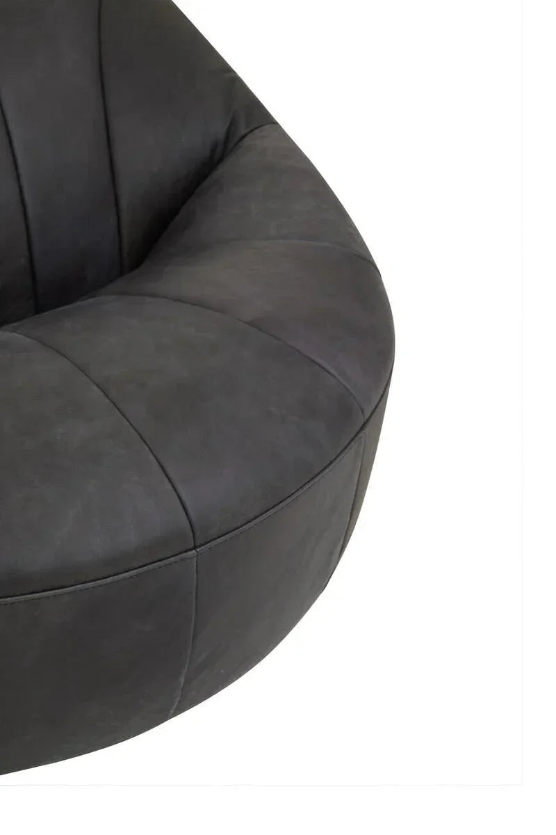 Close view of curved black fabric chair with panelled stitching detail