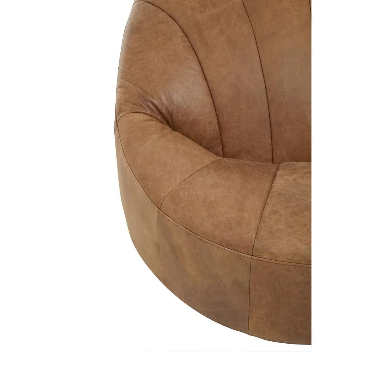 Closeup of curved brown leather sofa seat with stitched panel details