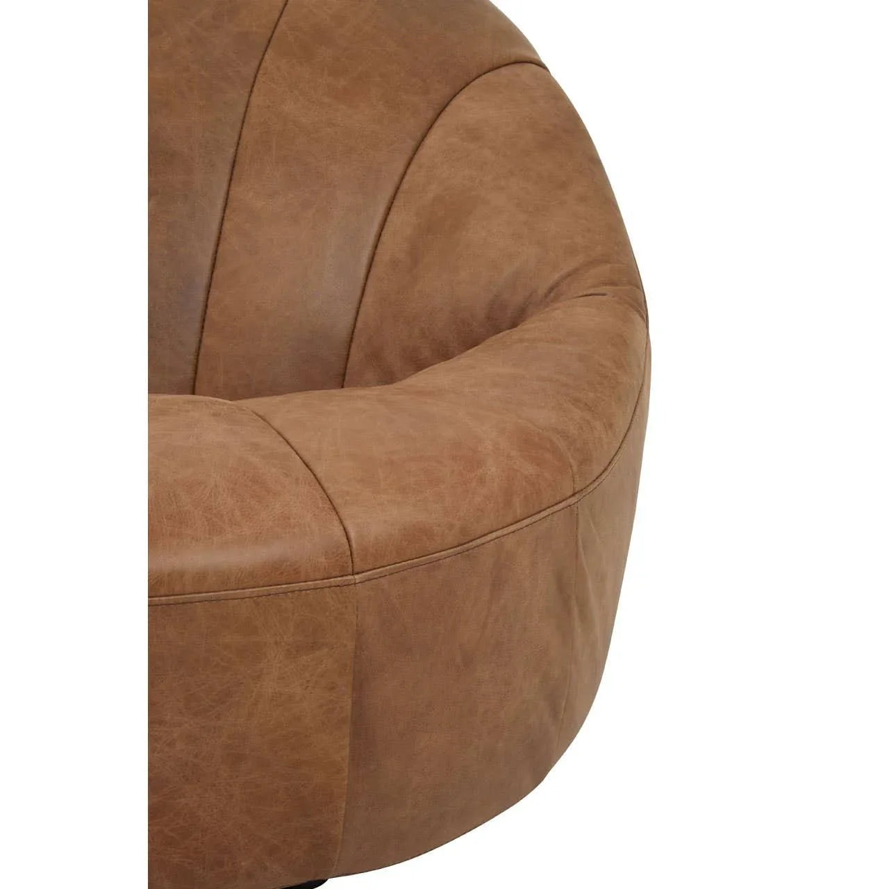 Close-up of brown leather armchair curved backrest and stitched panel detailing