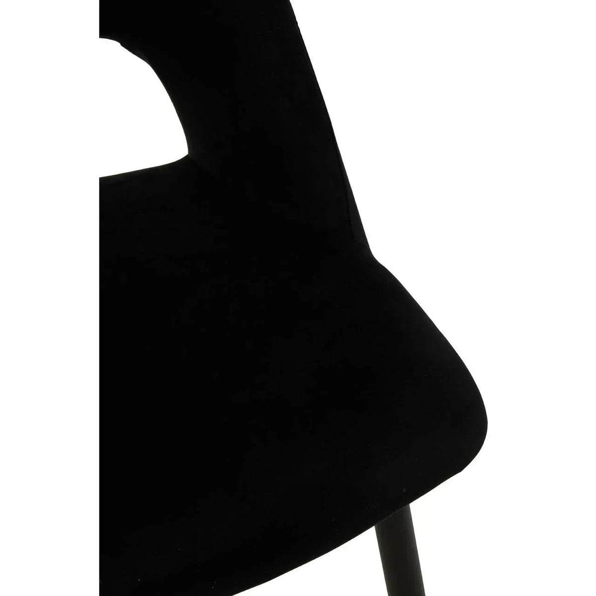 Close-up of black velvet dining chair seat and backrest with slim metal leg