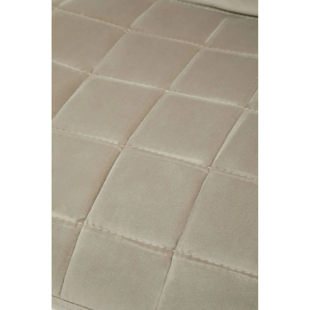 Beige velvet sofa cushion with square stitched detail, close-up view