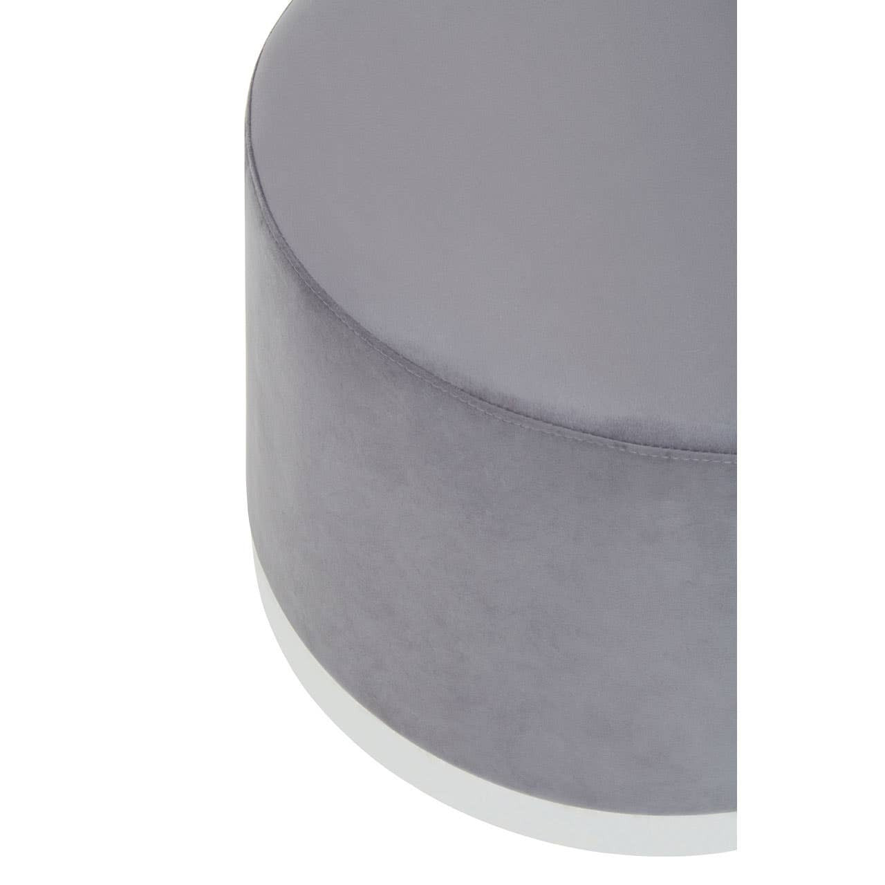 Round stool featuring a soft grey upholstery with a sleek silver base, showcasing a modern and minimalist design. The top surface is smooth and rounded, emphasizing its contemporary aesthetic