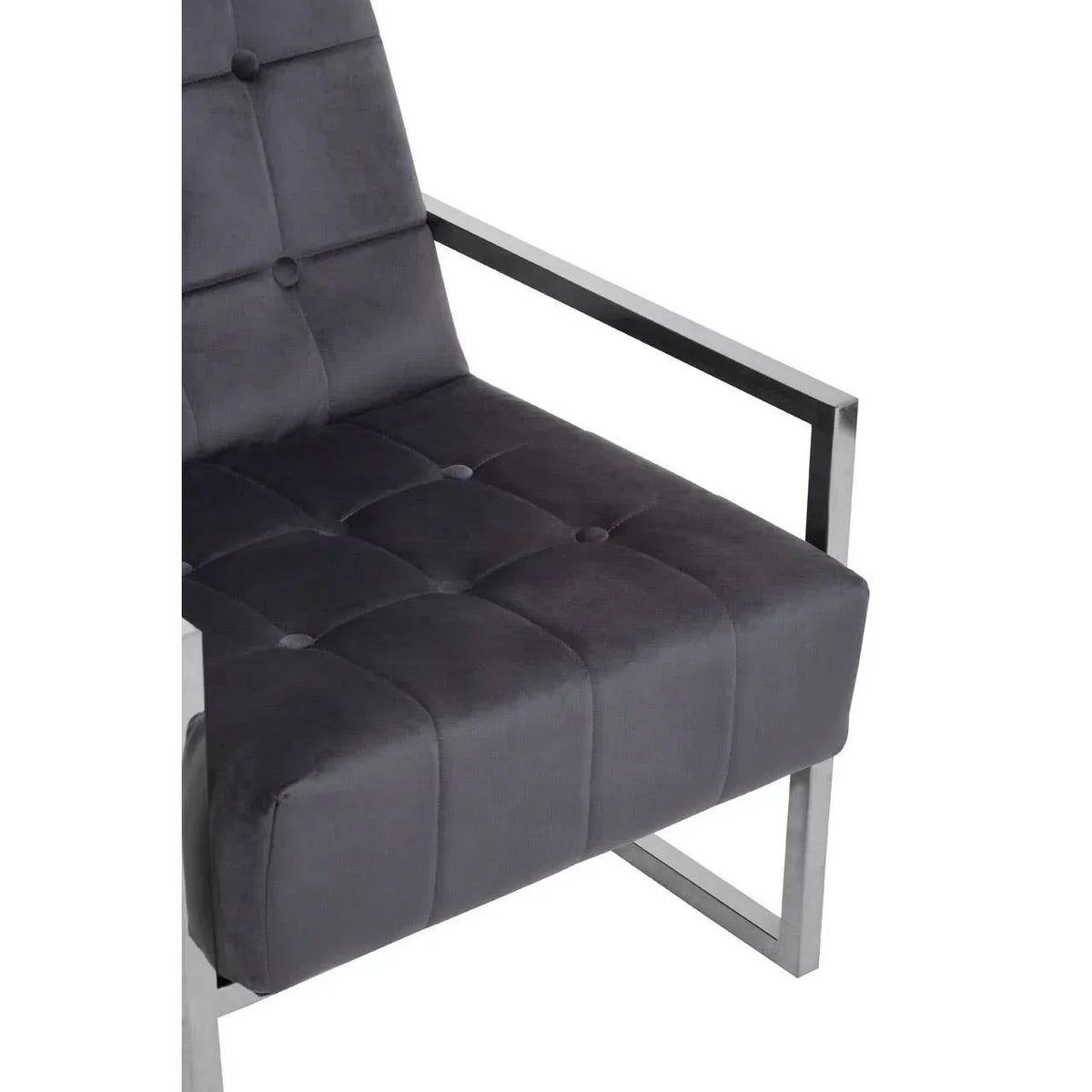 Grey velvet armchair with chrome metal frame and tufted seat detail