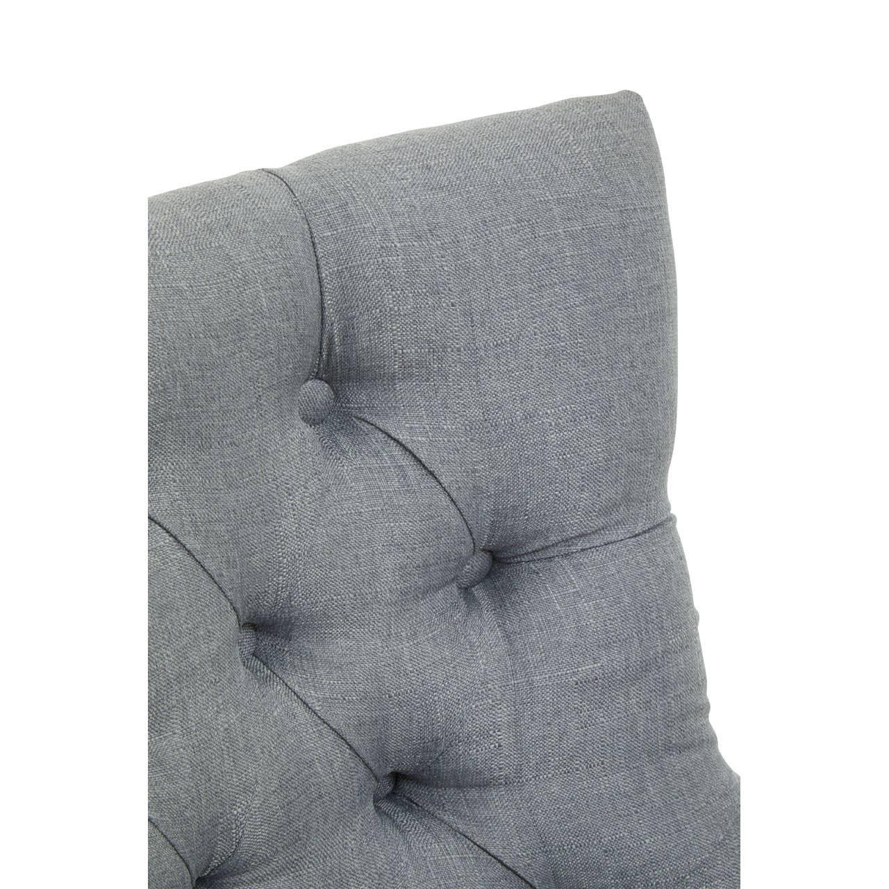 Close up of grey fabric tufted sofa backrest with button detail