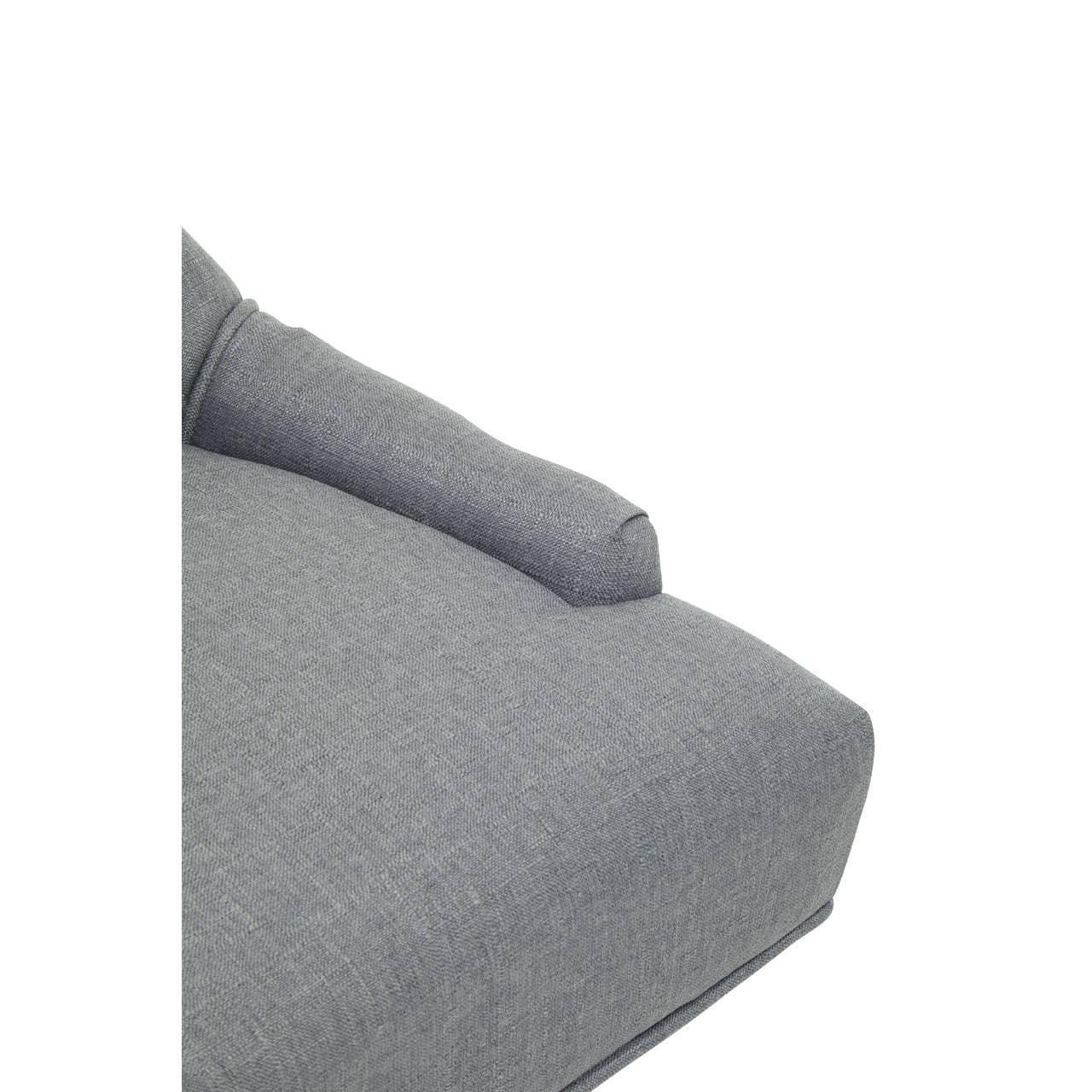 Closeup of grey fabric sofa armrest and seat cushion