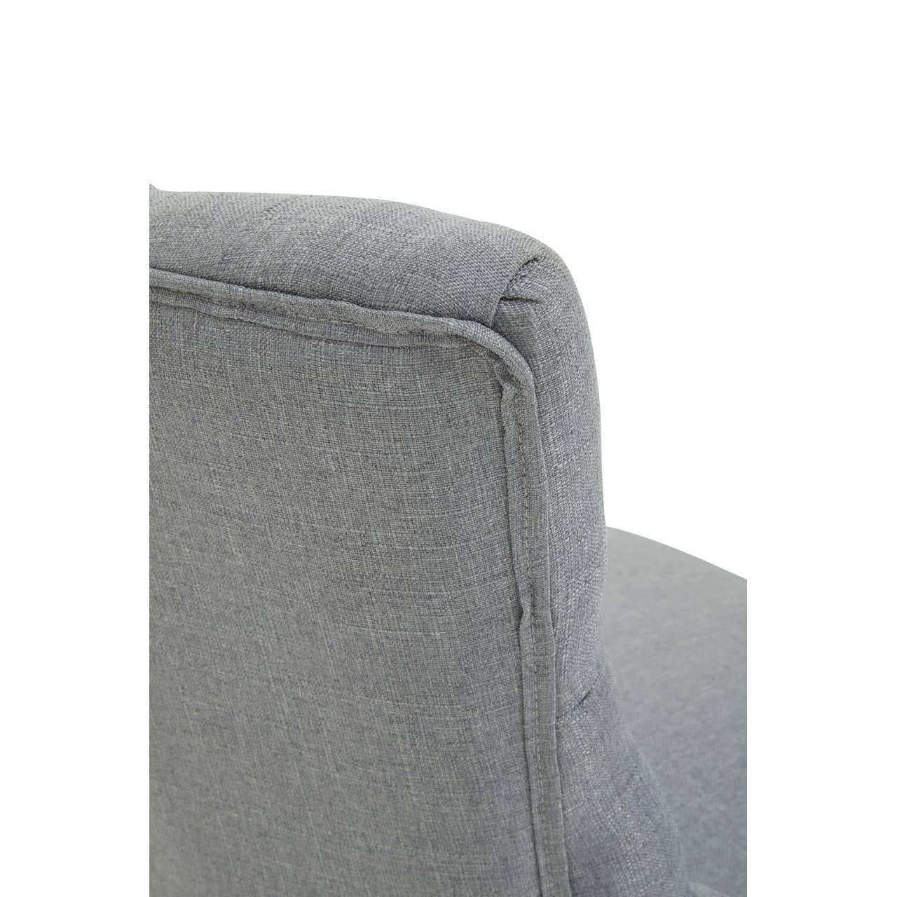 Closeup of grey fabric armchair backrest with visible stitching detail