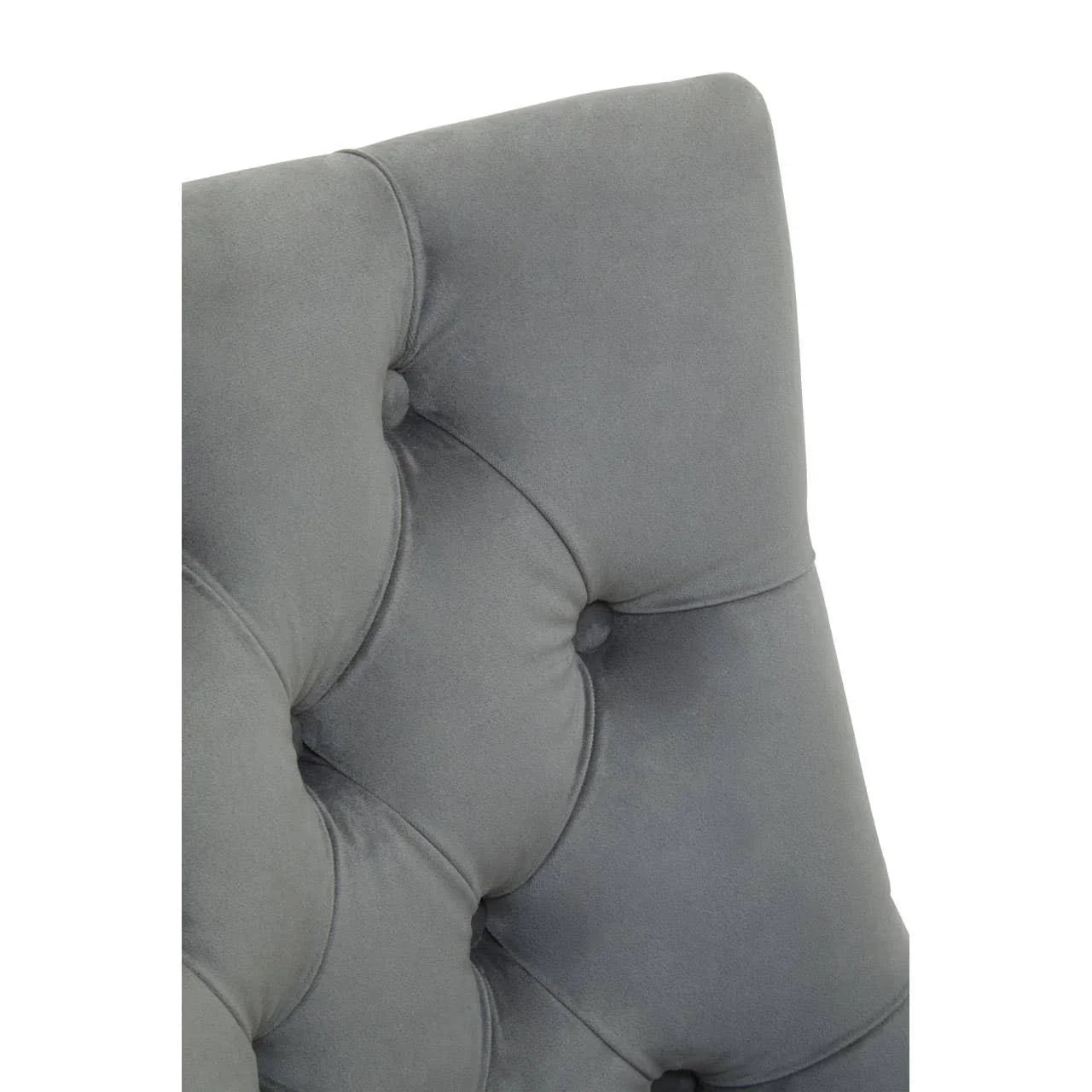 Grey velvet tufted chair backrest close-up with deep button details