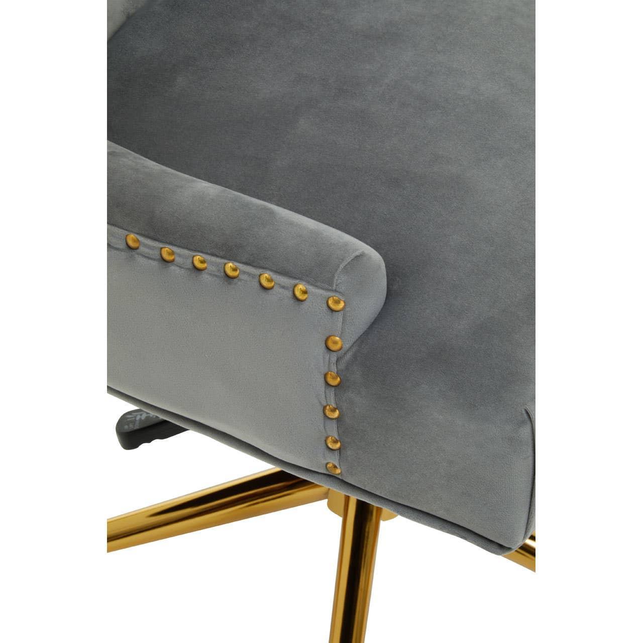 Grey velvet chair with gold stud detail and gold metal legs, close-up of armrest and base