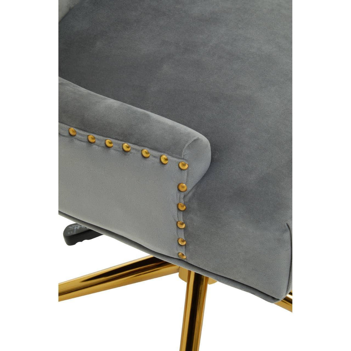 Grey velvet chair with gold stud detail and gold metal legs, close-up of armrest and base