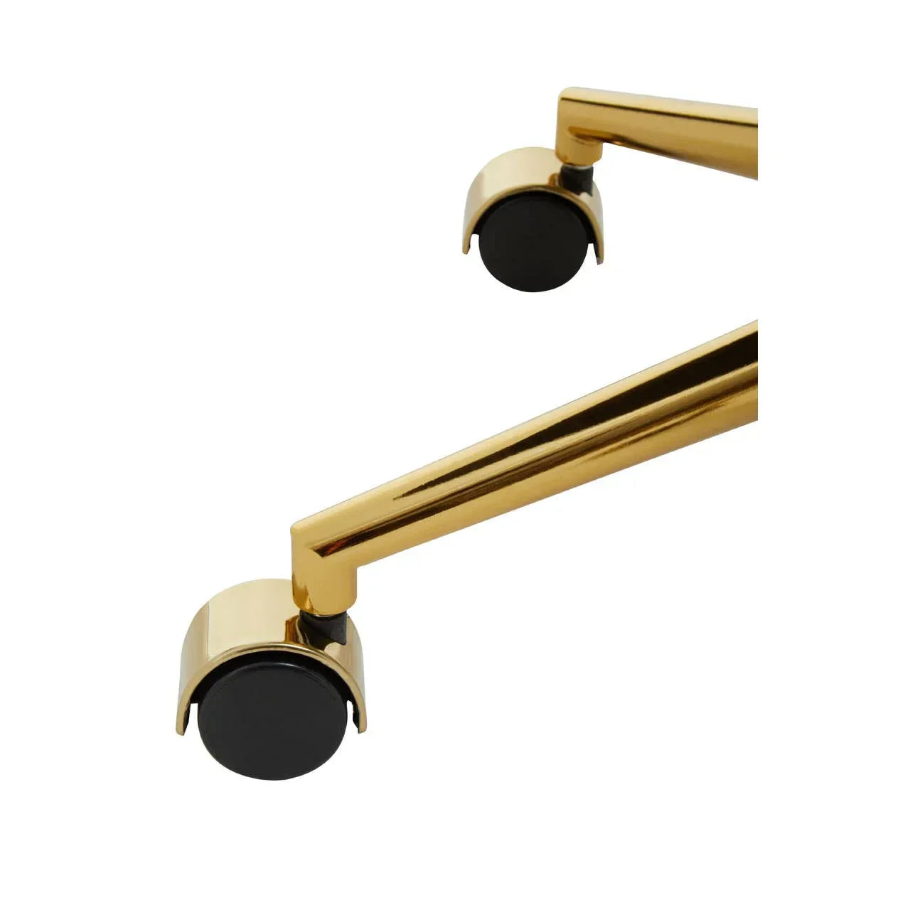 Gold metal furniture leg with black caster wheel, close-up of modern design detail