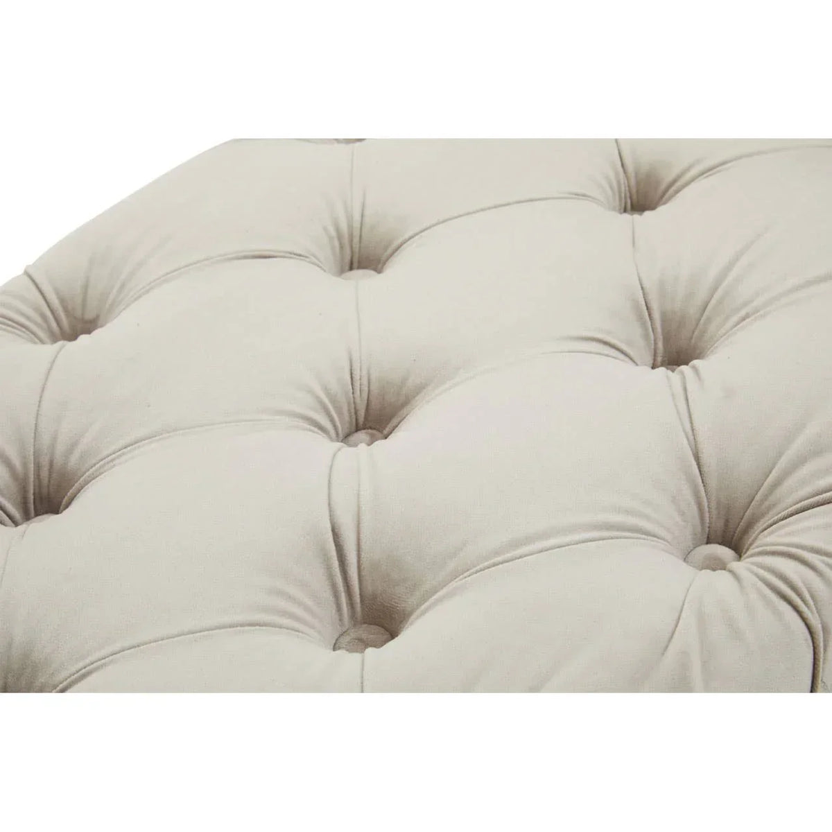 Closeup of beige tufted sofa upholstery with button details