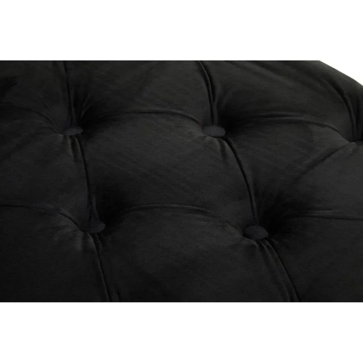 Black velvet sofa upholstery with deep button tufting close-up