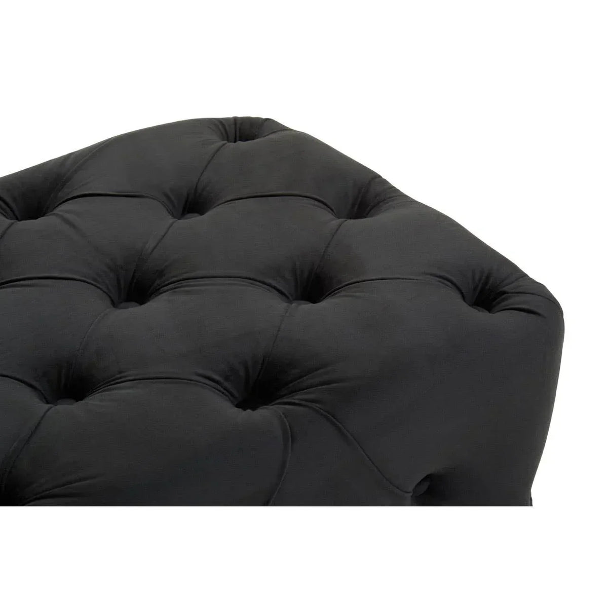 Close-up of black tufted ottoman upholstery with button detailing