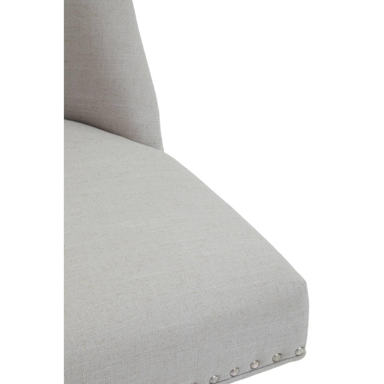 Light grey fabric dining chair seat with silver stud detailing on the edge