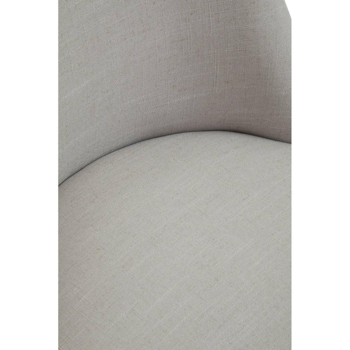 Closeup of light grey fabric armchair seat and curved backrest detail