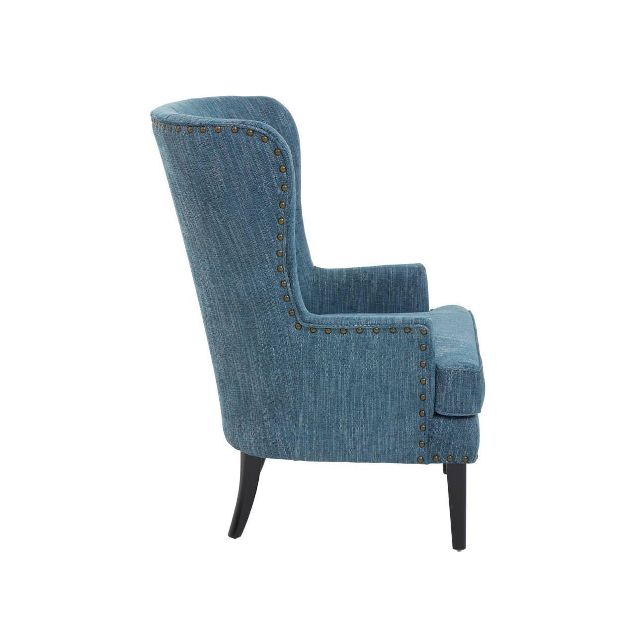 Blue fabric accent chair with studded trim and black wooden legs, side view