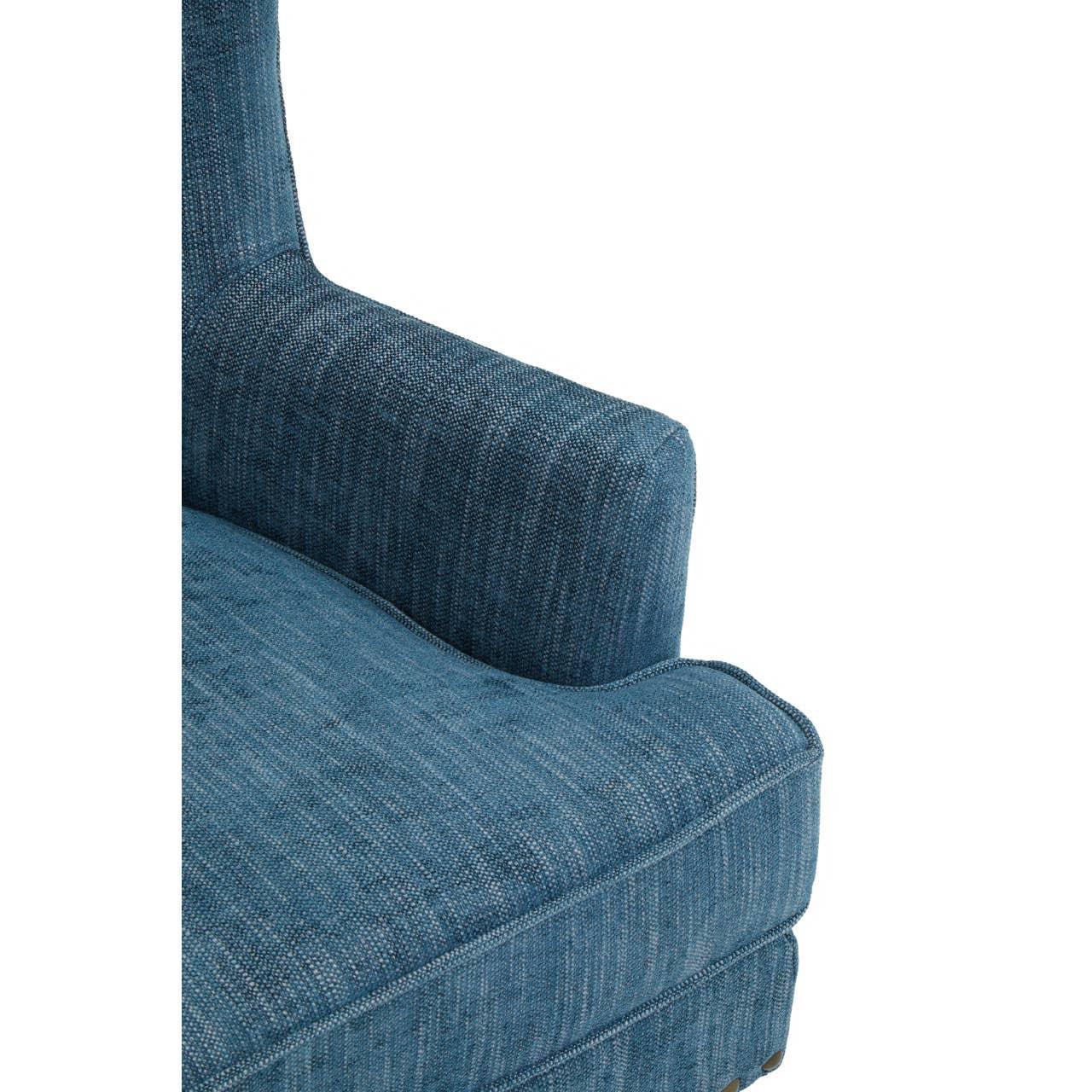 Closeup of blue fabric sofa arm and seat cushion with textured upholstery