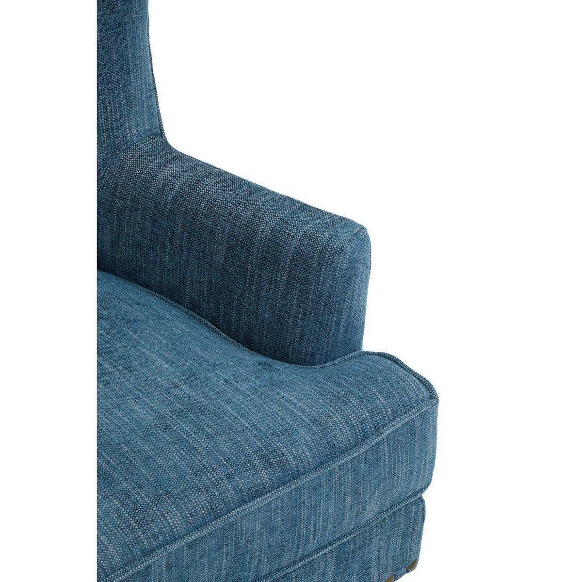 Closeup of blue fabric sofa arm and seat cushion with textured upholstery