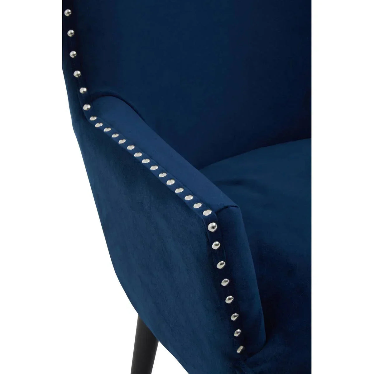 Navy blue velvet armchair with silver stud detailing along the armrest
