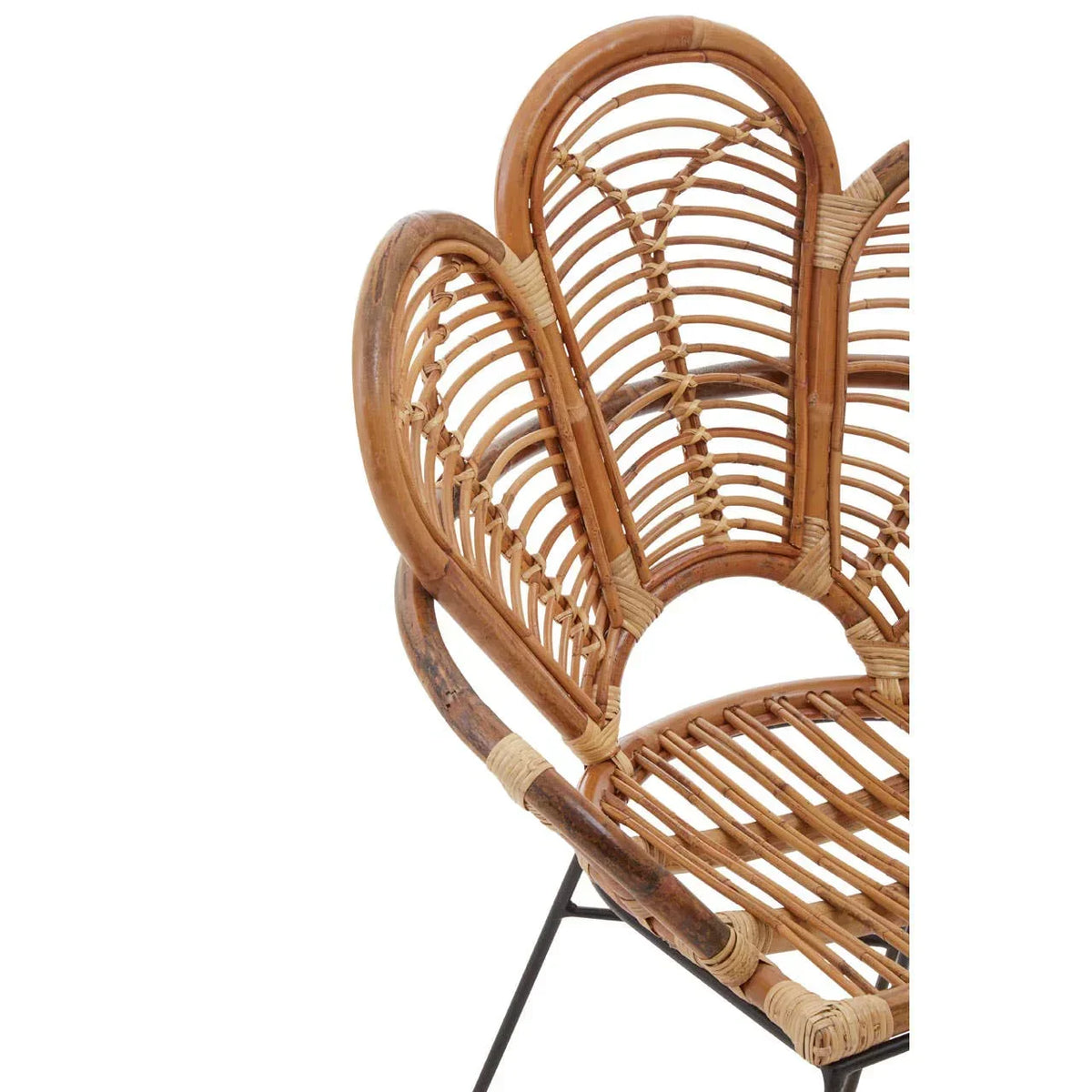 Curved rattan armchair with open weave backrest and black metal legs, close-up view