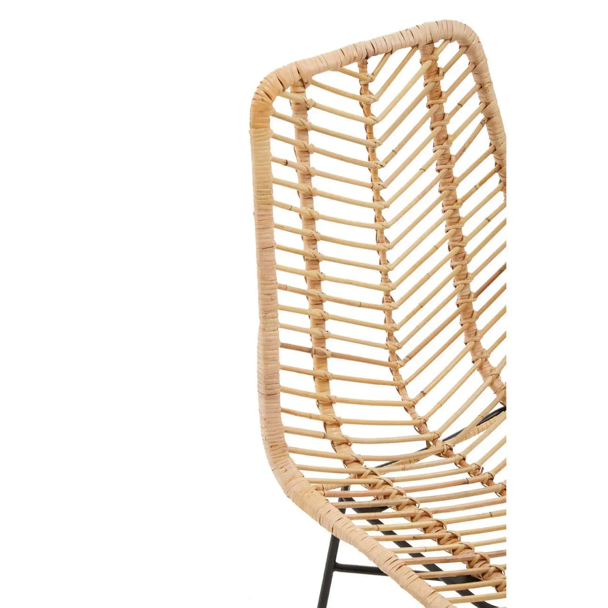 Close-up of rattan dining chair with curved backrest and black metal frame