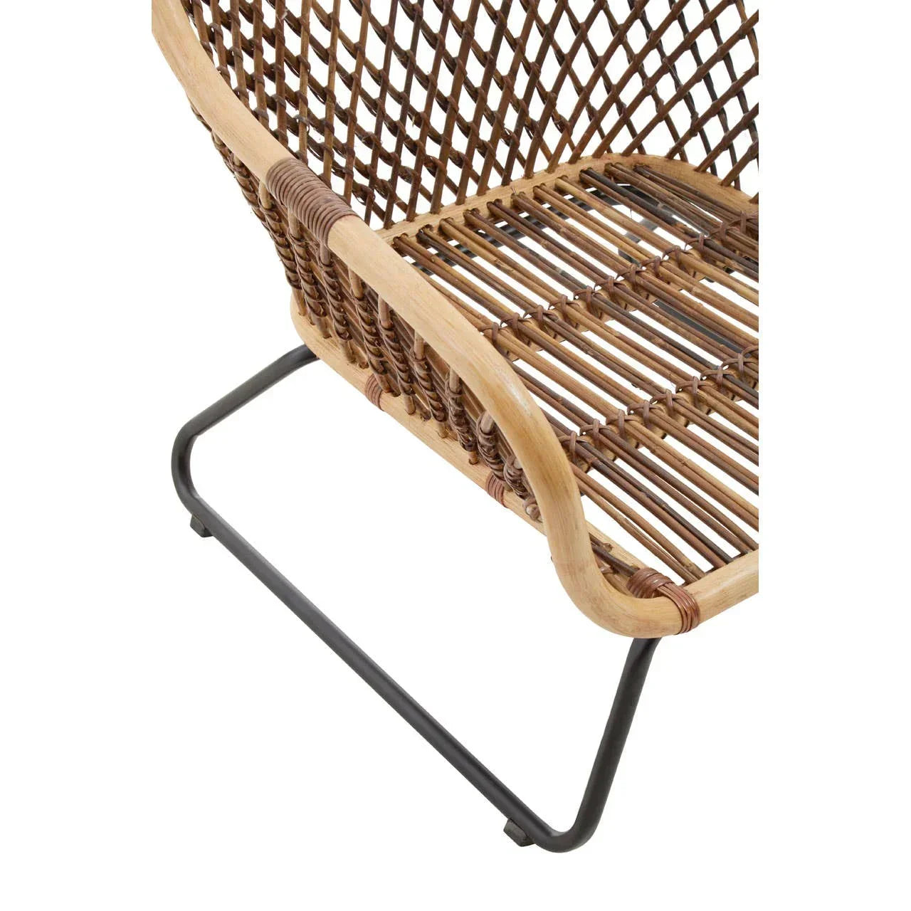 Closeup of rattan accent chair with woven seat and black metal legs
