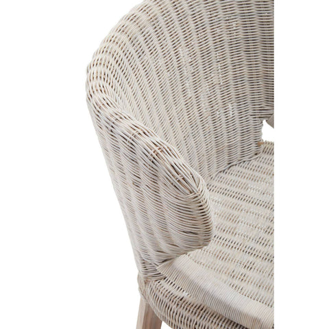 A close-up view of the Manado Wicker Chair showcasing its textured woven seat and backrest in a light, natural color, with a curved armrest and wooden legs