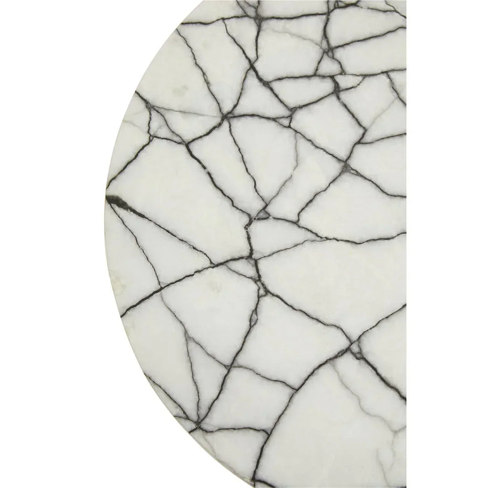 Round white marble table top with black veining pattern, close-up view