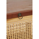 A close-up view of a Kendari Rattan and Leather Storage Box Side Table featuring a smooth leather top and a woven rattan body. The front has a decorative metal ring pull for easy access to the storage compartment. The natural tones of the rattan contrast with the rich leather finish