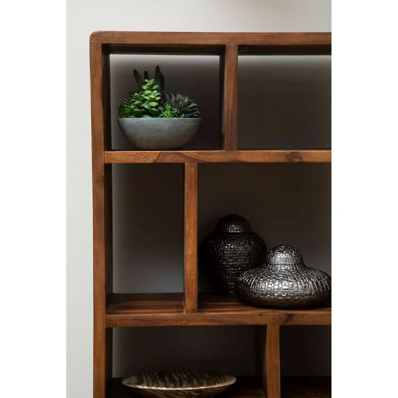 Wooden shelving unit with potted succulents and decorative metallic vases