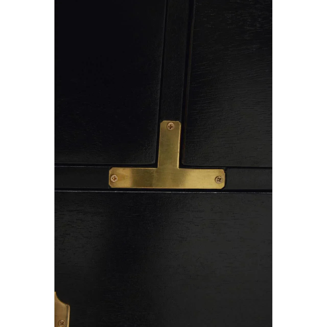 Closeup of black wood cabinet with gold metal corner bracket detail
