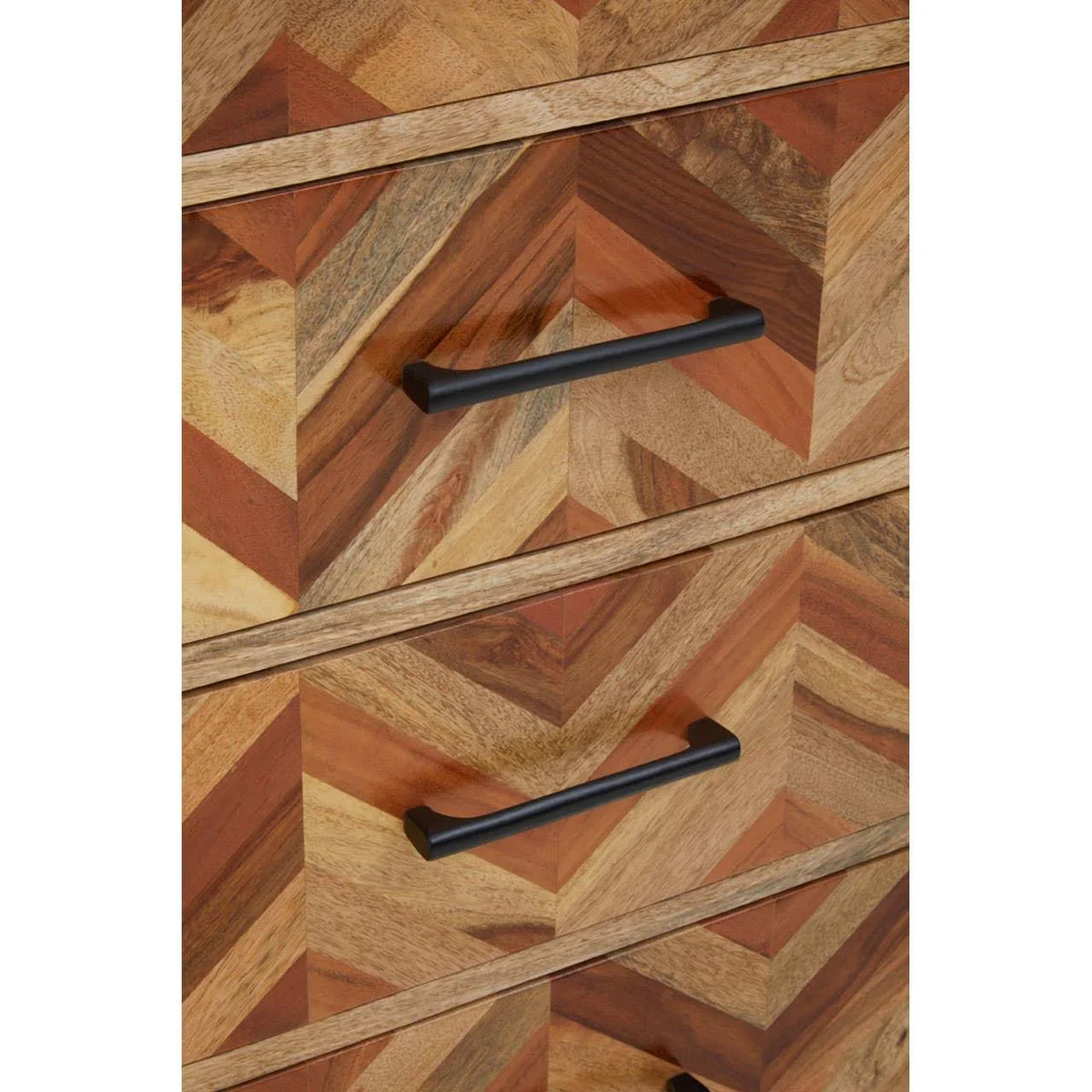 Chevron wood chest of drawers with black metal handles, close up on drawer fronts