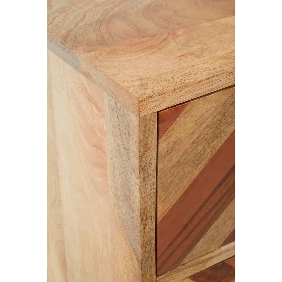 Close view of wooden cabinet with chevron pattern on the drawer front