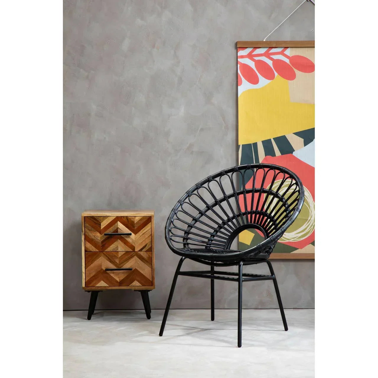 Black rattan accent chair beside geometric wood bedside table in modern room