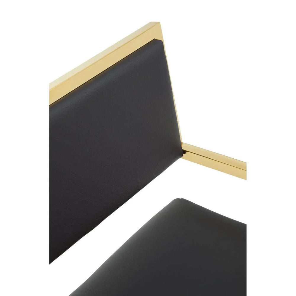 Black faux leather chair with gold metal frame, closeup of backrest and seat