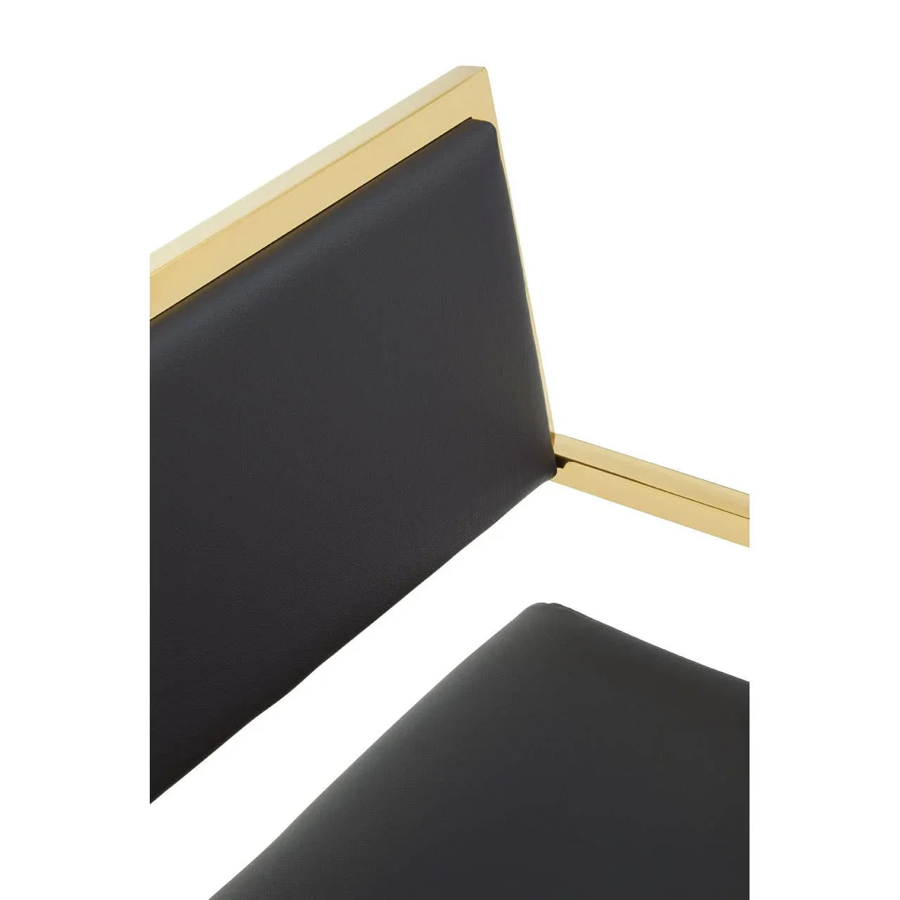 Black faux leather chair with gold metal frame, closeup of backrest and seat