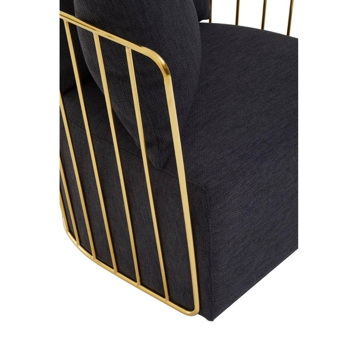 Black upholstered armchair with gold metal frame closeup
