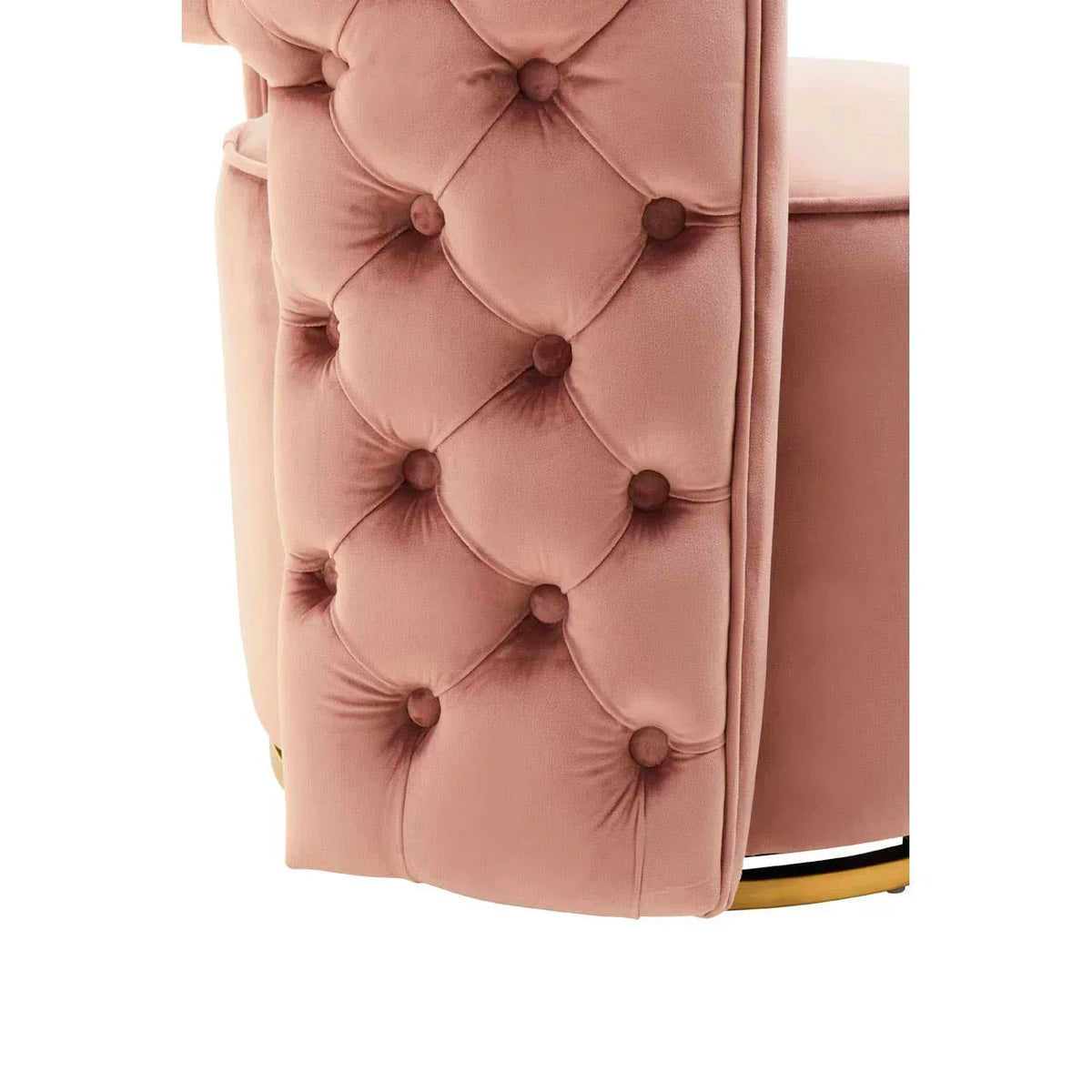 Close-up of blush pink velvet chair with button tufting and gold metal base