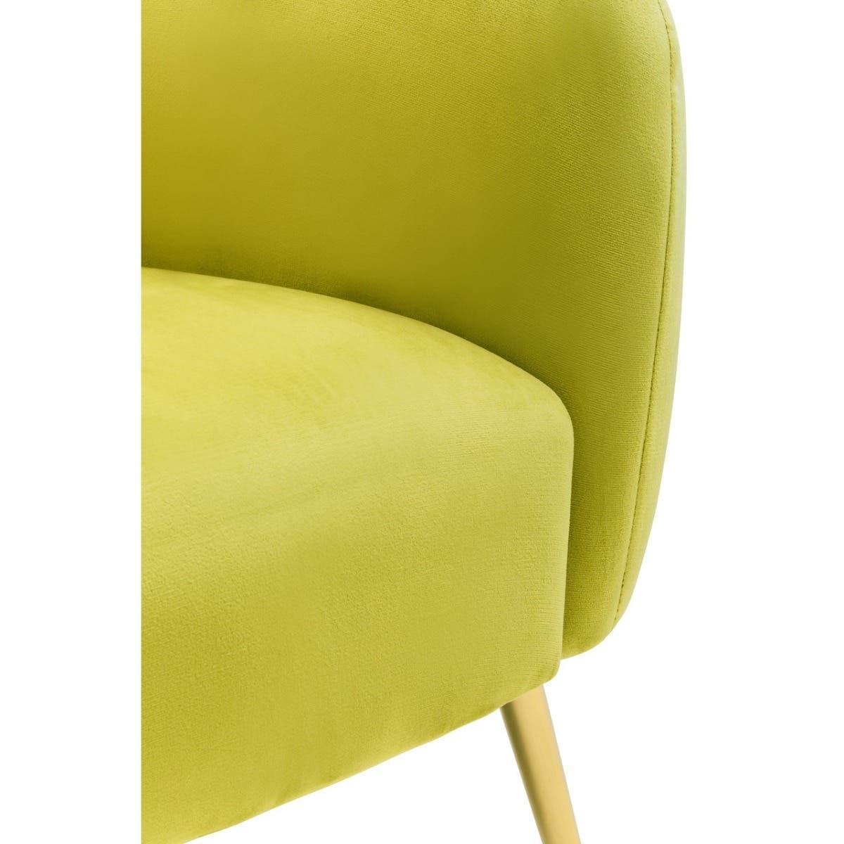 Close-up of green velvet accent chair with curved backrest and angled wooden leg