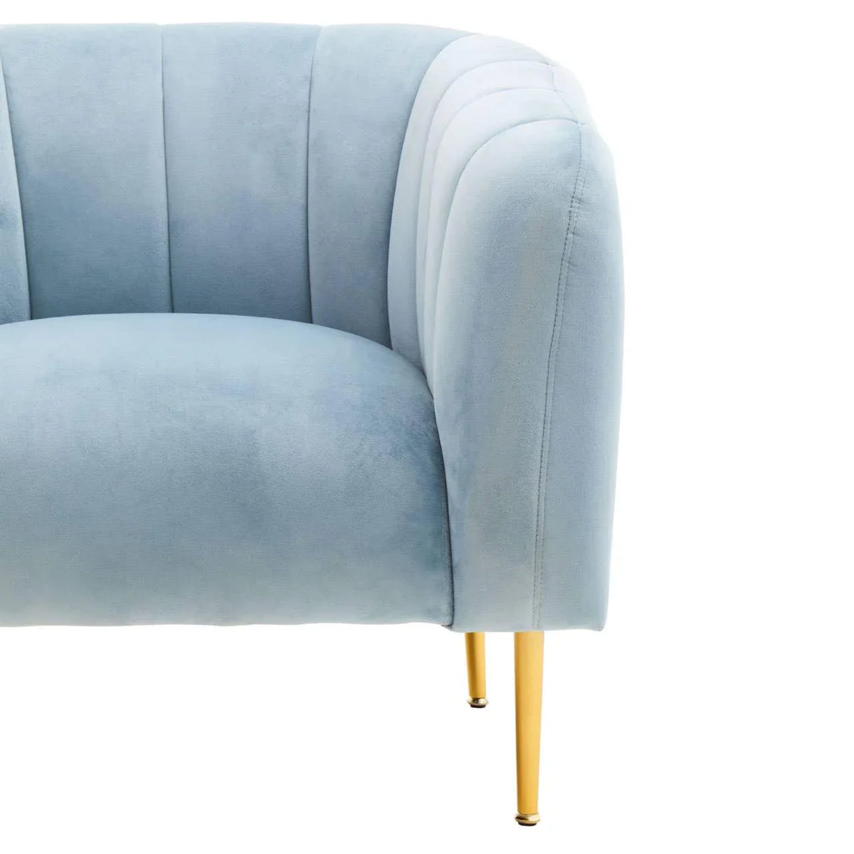 Light blue velvet armchair with curved back and gold metal legs, close-up view