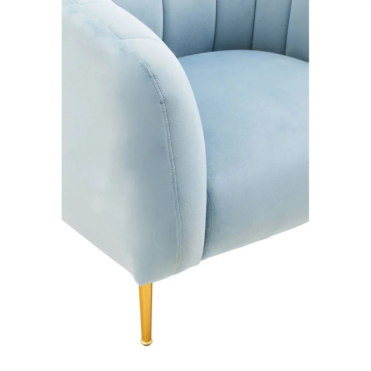 Light blue velvet armchair with gold metal leg, close-up on seat and armrest