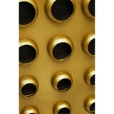 Close-up of a tall cabinet featuring a brass effect door with a pattern of circular cutouts, showcasing a sleek and modern design. The background is a solid color, emphasizing the cabinet's metallic finish and unique texture