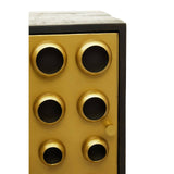Tall cabinet featuring a sleek design with a mango wood finish and brass effect accents. The cabinet has two doors with circular brass handles, and the front displays a grid of six round, black mesh panels. The overall color scheme combines warm wood tones with metallic gold elements, creating a modern and stylish look suitable for home decor