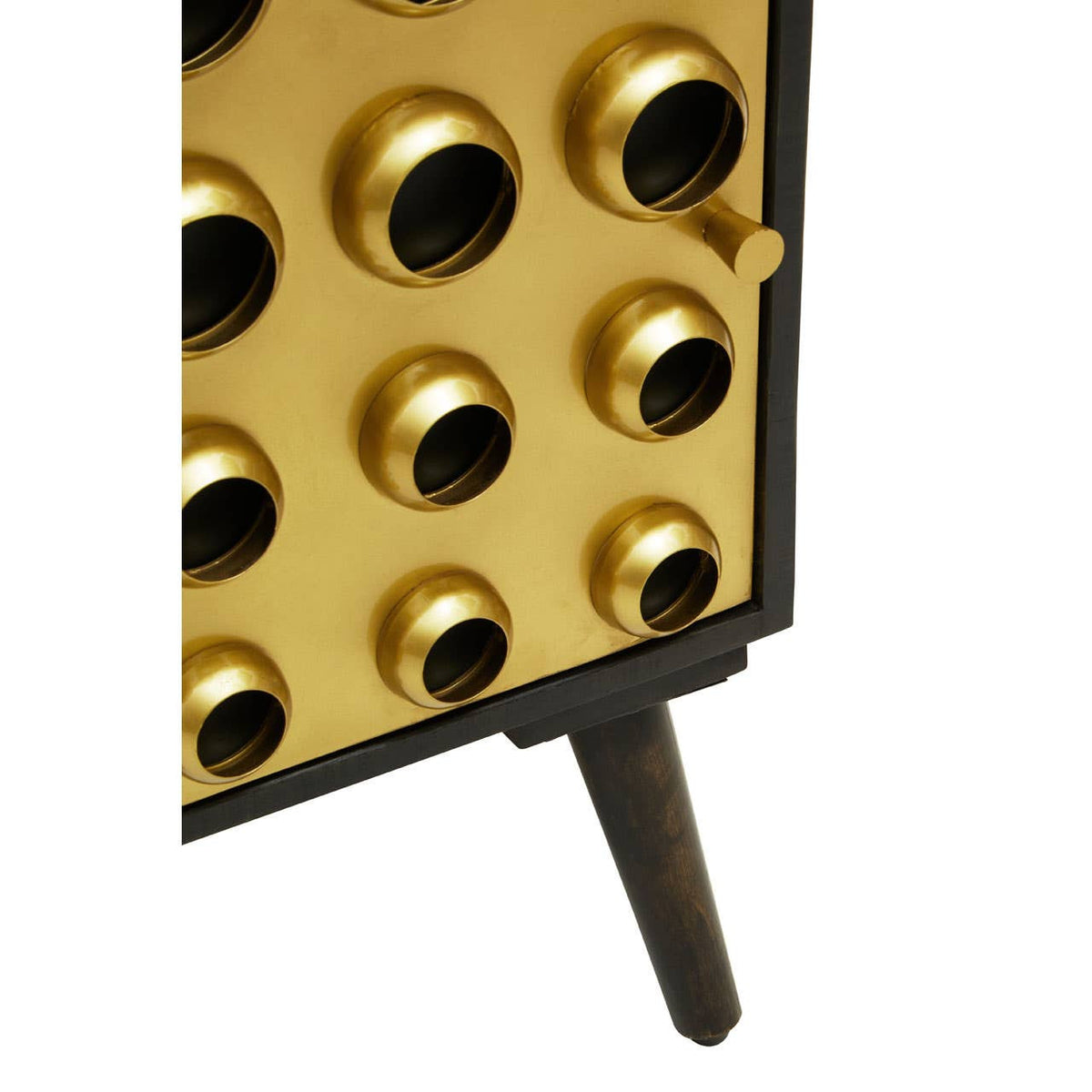 Mango wood cabinet featuring a brass effect door with circular cutouts, supported by a sleek black base and a single tapered leg. The design showcases a modern aesthetic with a combination of natural wood and metallic elements