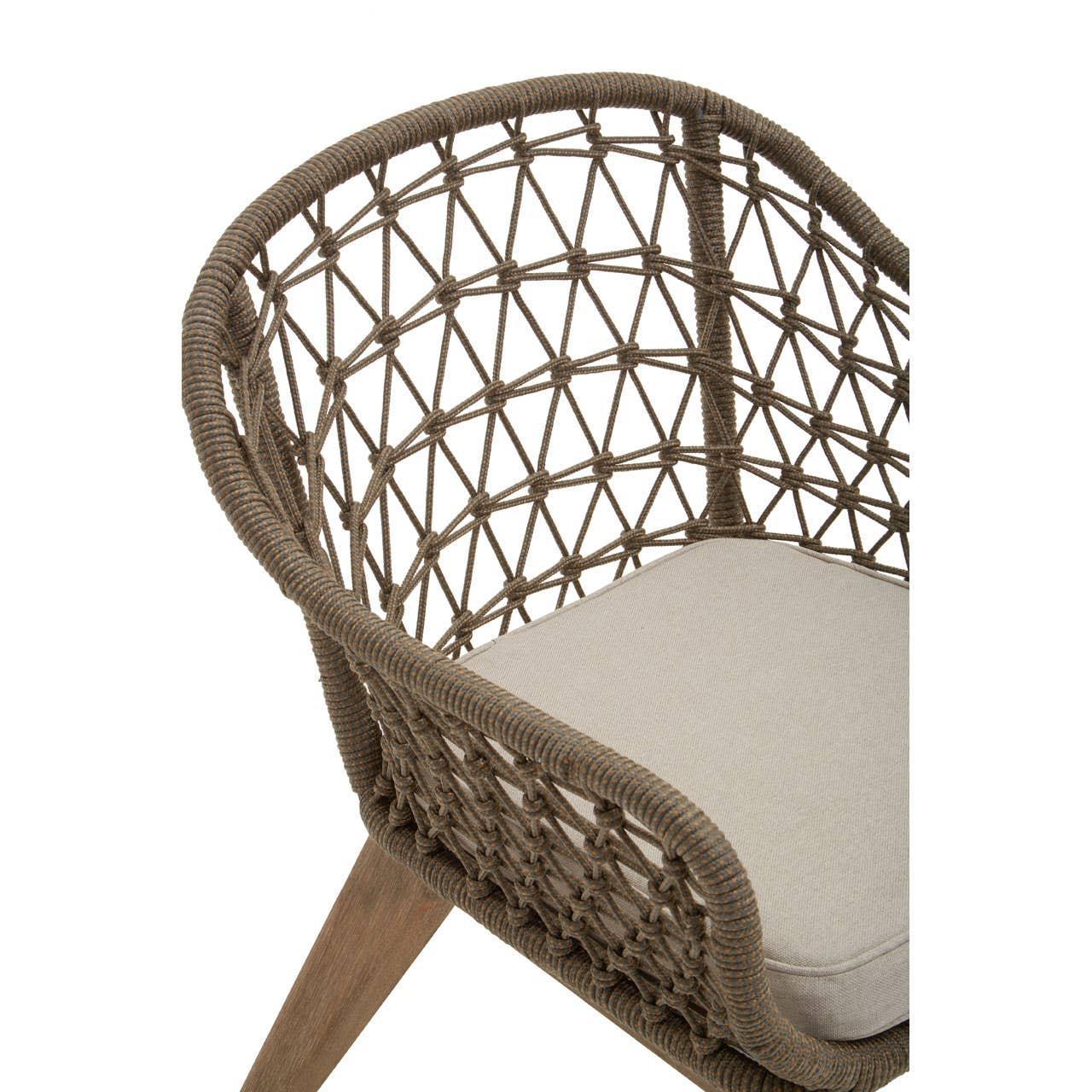 Woven rope armchair with beige cushion and wooden legs, shown from a side angle