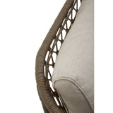 A close-up view of the Opus Grey Woven Rope Three Seater Sofa, showcasing the intricate woven rope design along the armrest and the soft, light-colored cushions that provide comfort and style. The texture of the rope and fabric is highlighted, emphasizing the modern and elegant aesthetic of the sofa