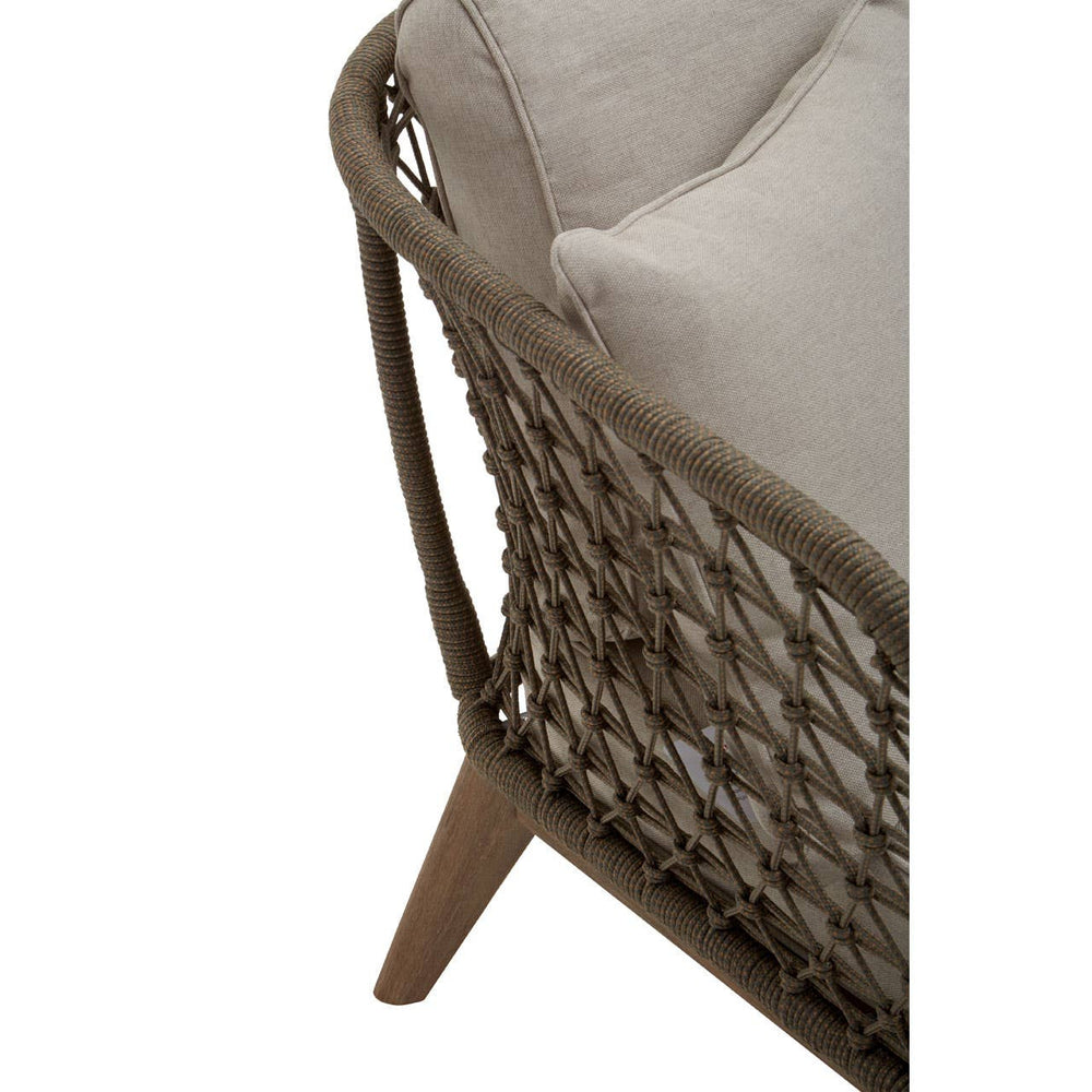 Three-seater sofa featuring a grey woven rope design with a sturdy frame and wooden legs. The sofa is adorned with plush, light-colored cushions for added comfort. The angle showcases the intricate weaving and the smooth finish of the wooden legs