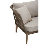 Woven rope chaise longue featuring a light beige cushion and a matching decorative pillow, supported by wooden legs with a natural finish. The design includes a curved backrest and a spacious seating area, ideal for outdoor relaxation